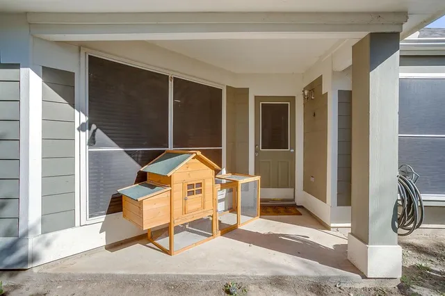 a backyard of a house with table and chairs