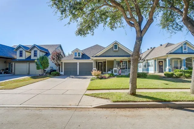 a front view of a house with a yard table and chairs
