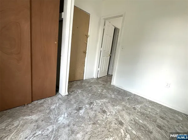 a view of a big room with closet and wooden floor