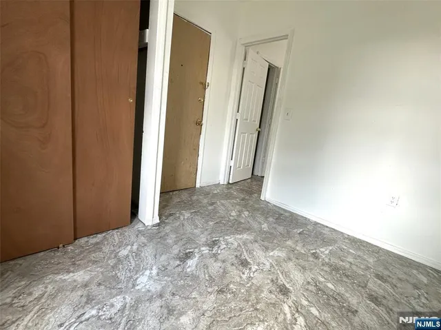 a view of a big room with closet and wooden floor