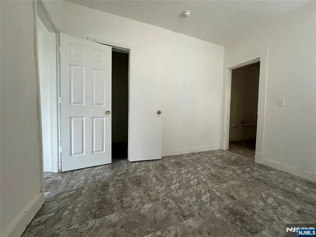 an empty room with closet area