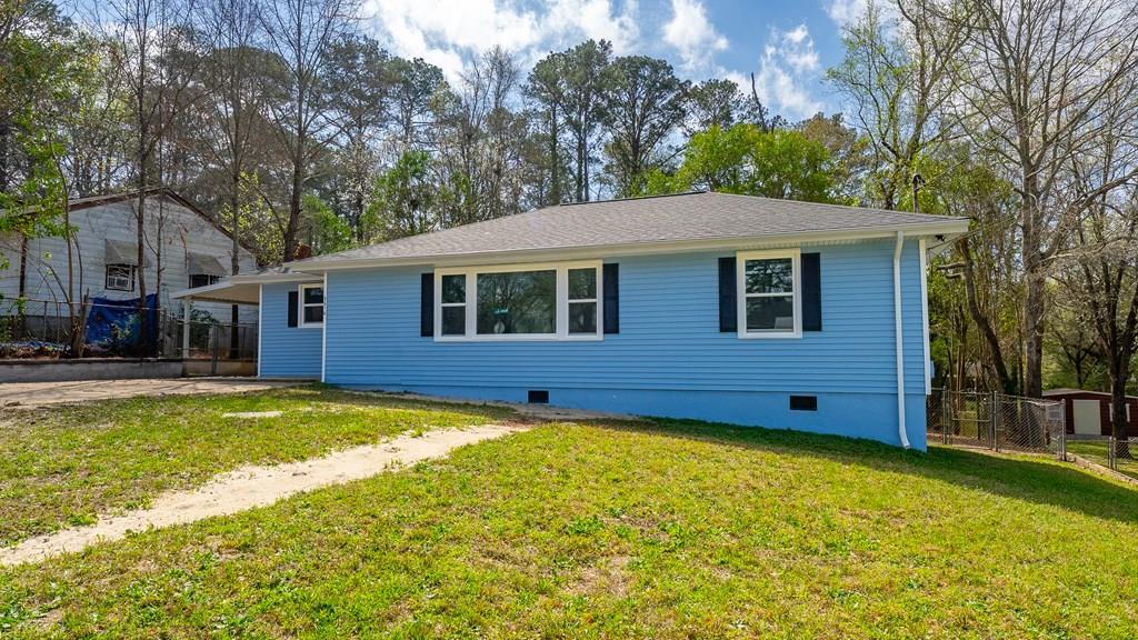 a view of a house with a swimming pool and a yard