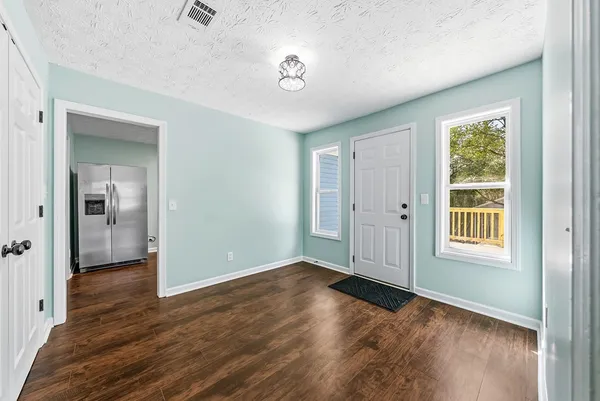 wooden floor in an empty room with a window