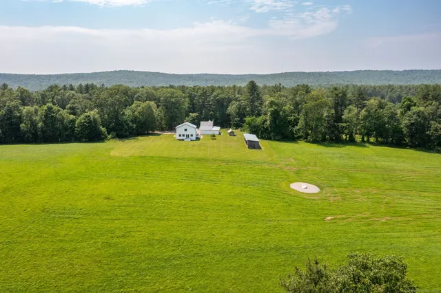 a view of a field with an ocean