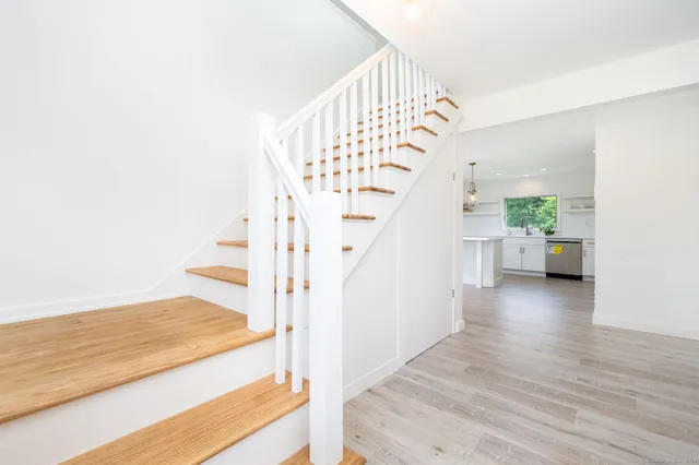 a view of entryway and hall with wooden floor