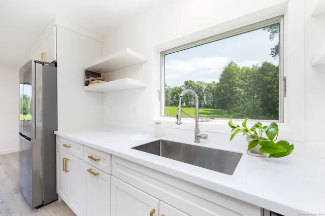 a kitchen with a sink and a large window