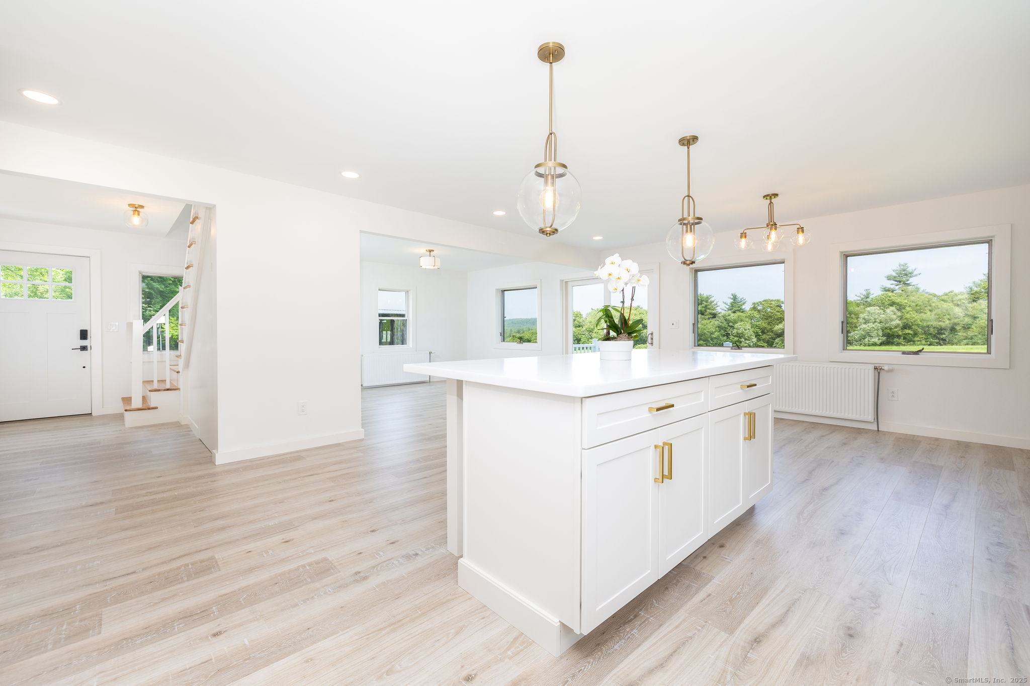 1669 Highway 169 Woodstock, CT 06281 - Photo 20 of 39 a large white kitchen with kitchen island white cabinets and wooden floor