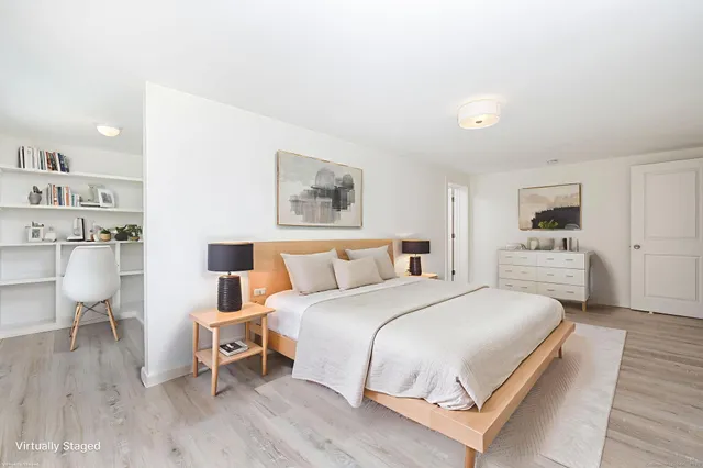 a view of a walk in closet with wooden floor