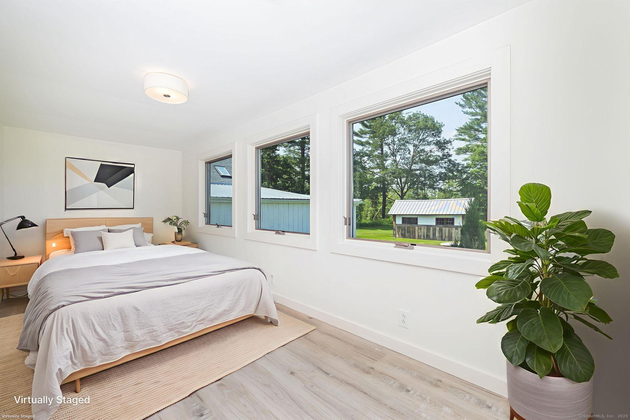 1669 Highway 169 Woodstock, CT 06281 - Photo 28 of 39 a bedroom with a bed running cycle and a window