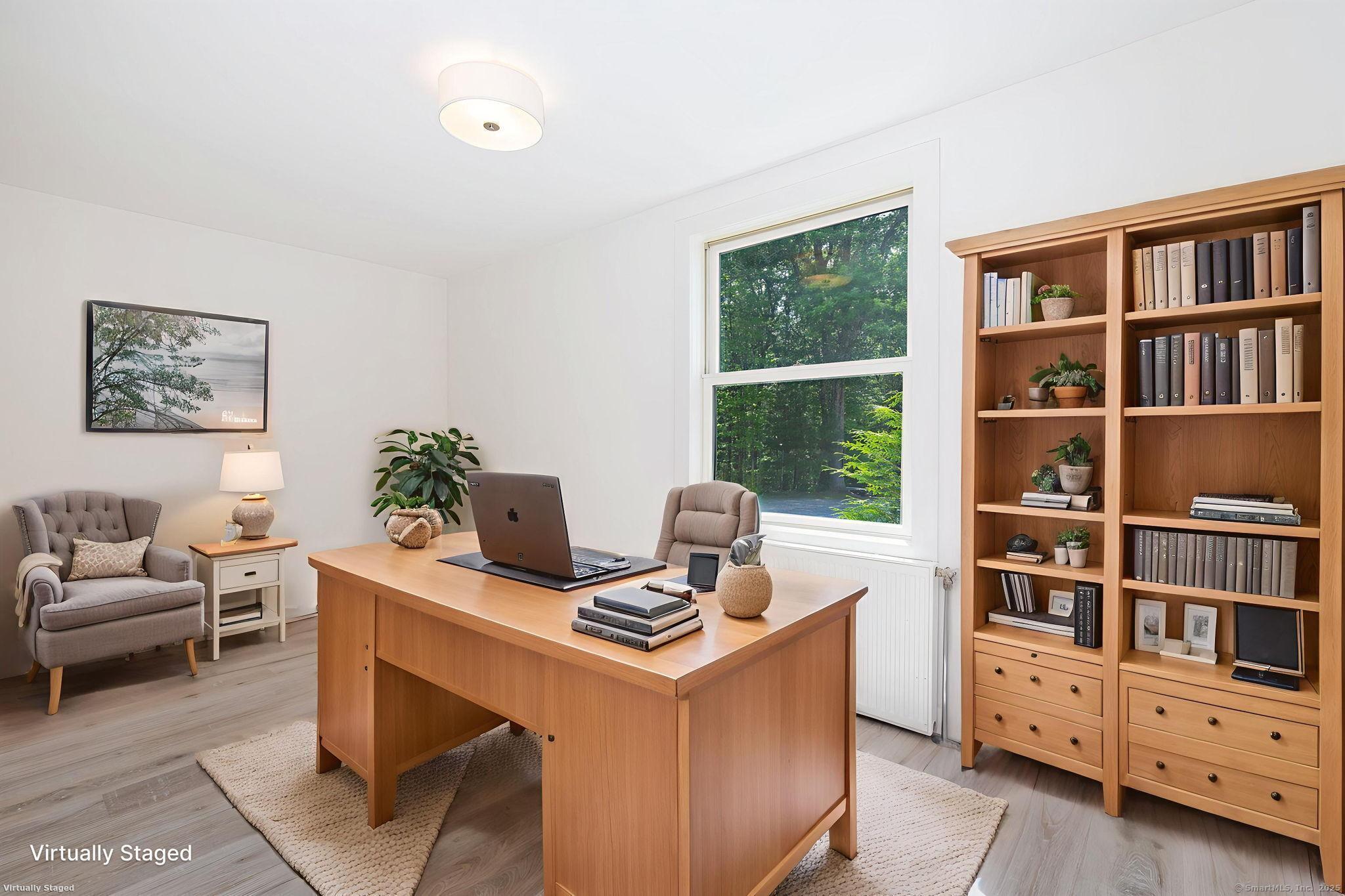 1669 Highway 169 Woodstock, CT 06281 - Photo 30 of 39 a view of a workspace with furniture and a bookshelf