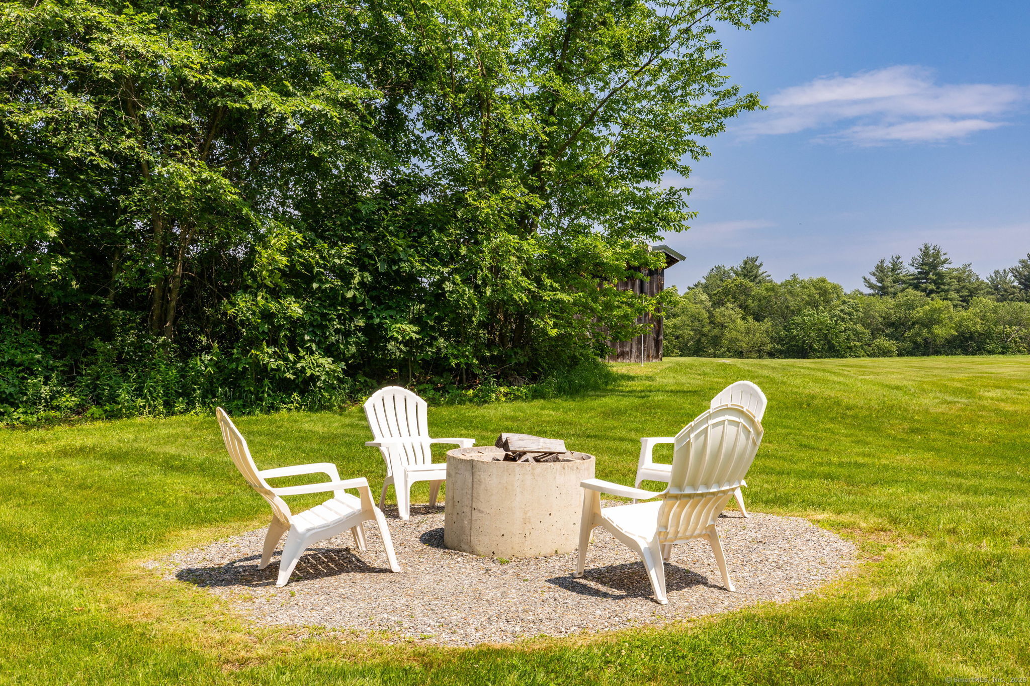 1669 Highway 169 Woodstock, CT 06281 - Photo 7 of 39 a table and chair sitting in the grass near a lake
