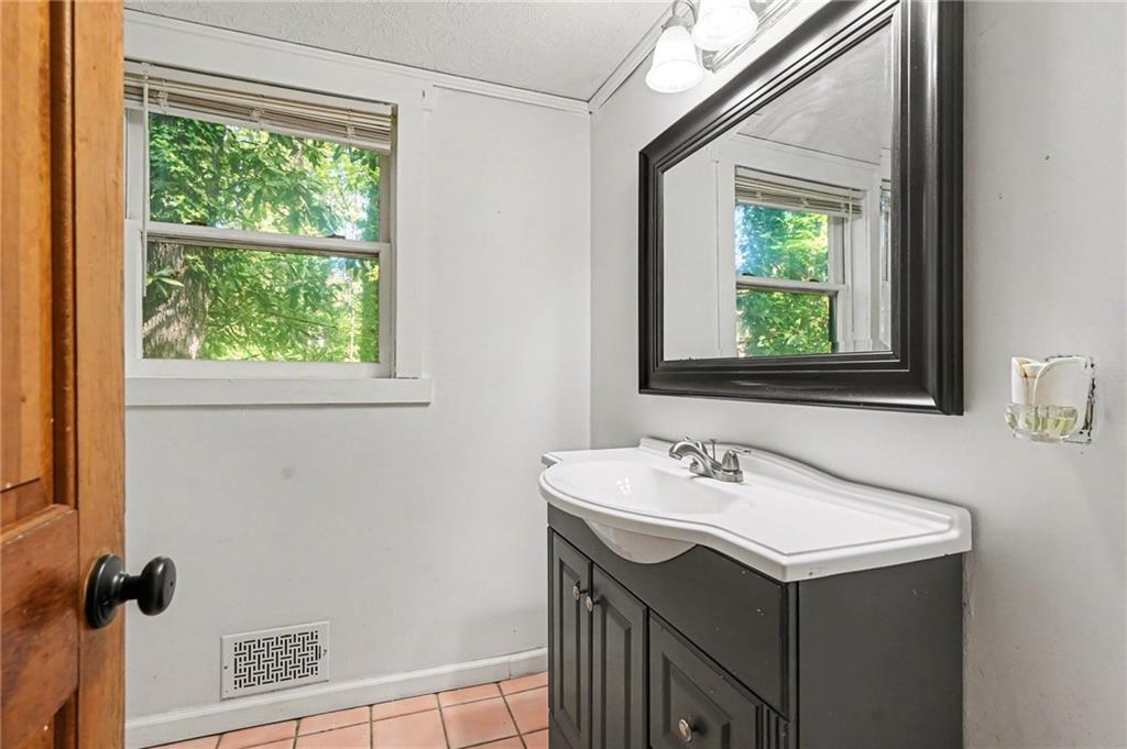 2530 Rockbridge Road Northwest Conyers, GA 30012 - Photo 26 of 45 a bathroom with a sink and a mirror
