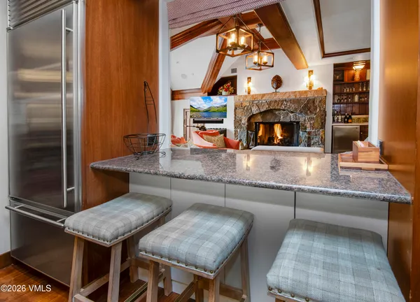 a bathroom with a granite countertop double vanity sink and a bathtub