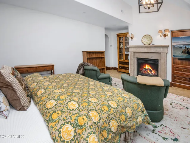 a patio with a table and chairs and potted plants