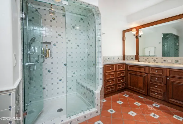 a living room with furniture a fireplace and a floor to ceiling window