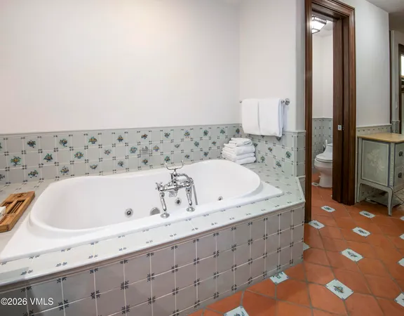 a living room with furniture a rug and a chandelier