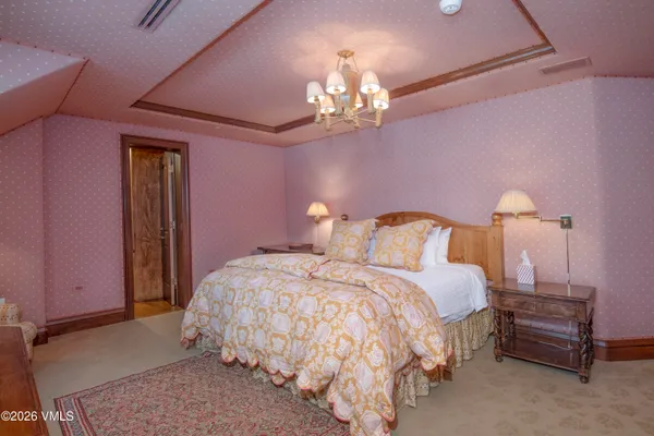 a living room with furniture a fireplace and a floor to ceiling window