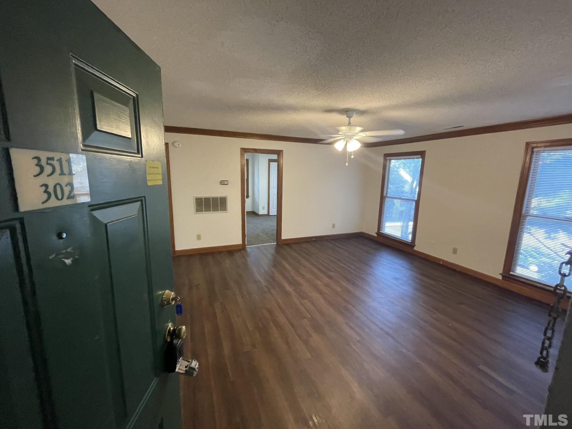 3511 Ivy Commons Drive, Unit 302 Raleigh, NC 27606 - Photo 1 of 9 wooden floor in an empty room with a window