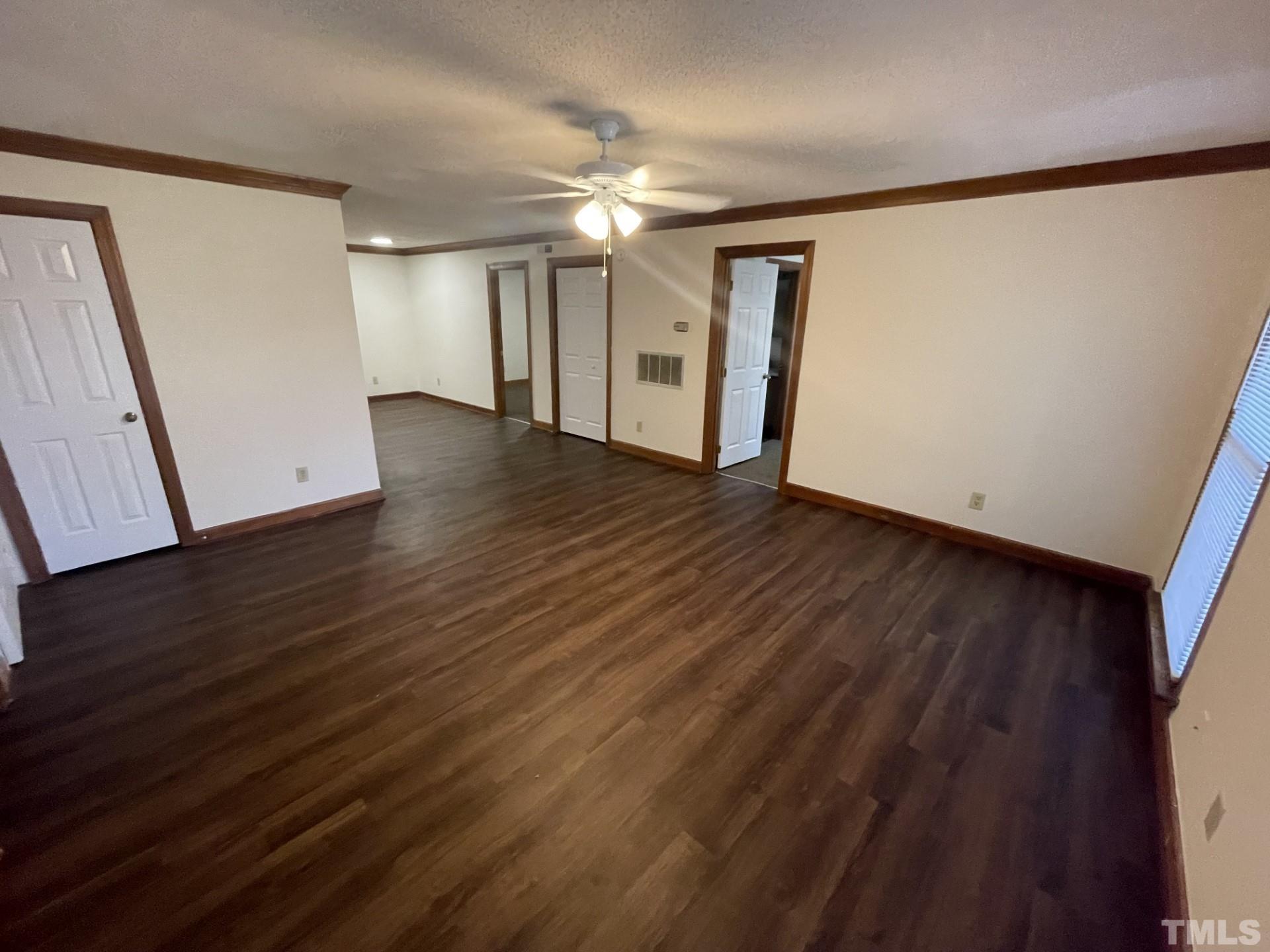 3511 Ivy Commons Drive, Unit 302 Raleigh, NC 27606 - Photo 2 of 9 a view of an empty room with wooden floor and a window