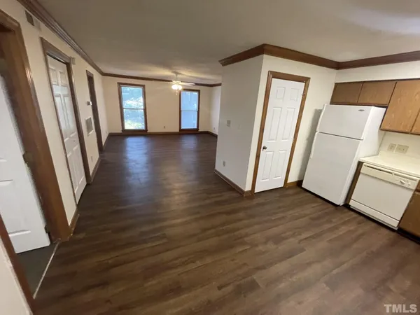 a view of a room with wooden floor and fence