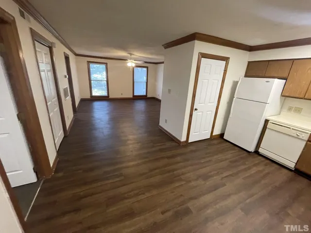 a view of a room with wooden floor and fence