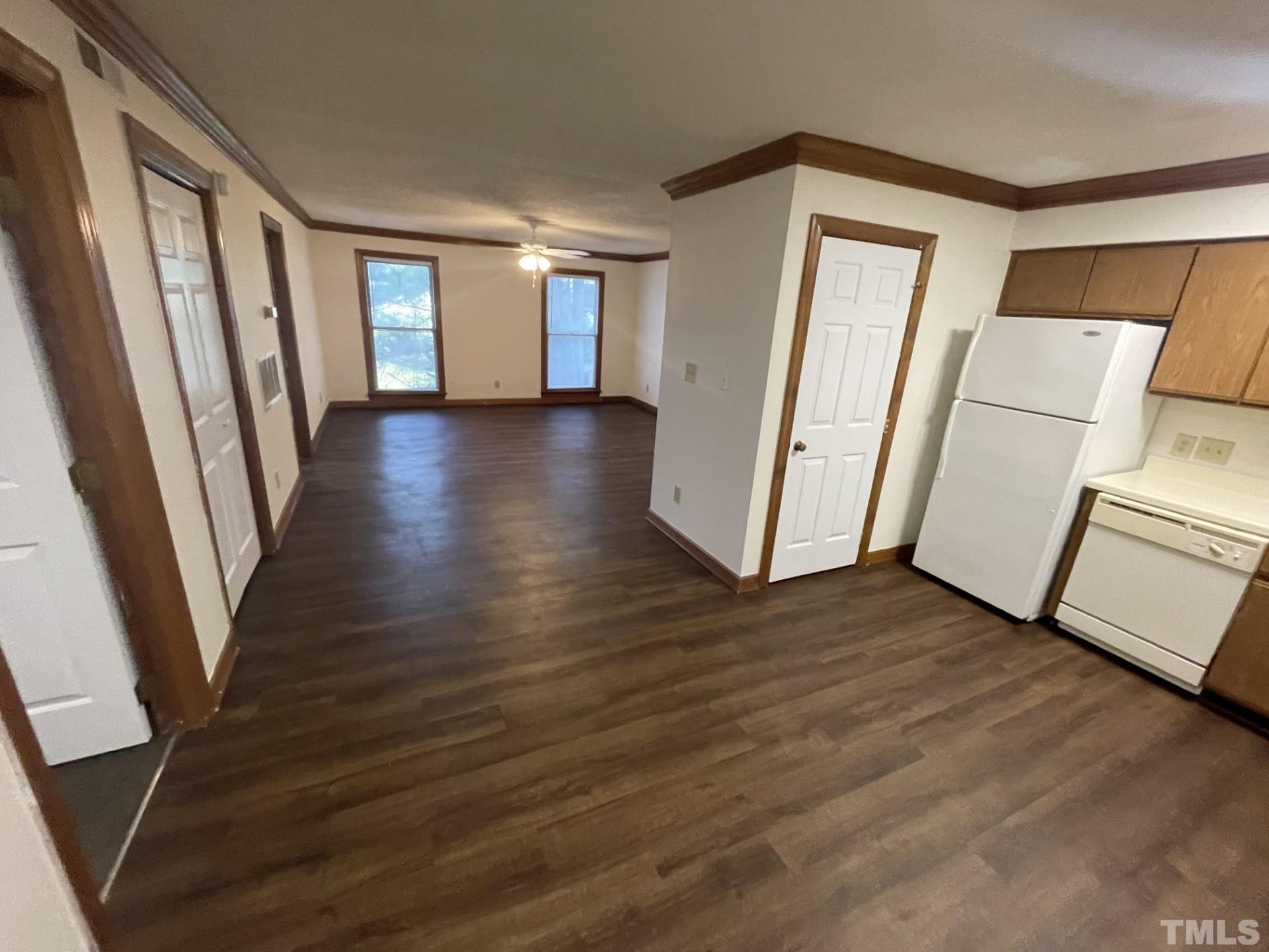 3511 Ivy Commons Drive, Unit 302 Raleigh, NC 27606 - Photo 5 of 9 a view of a room with wooden floor and fence