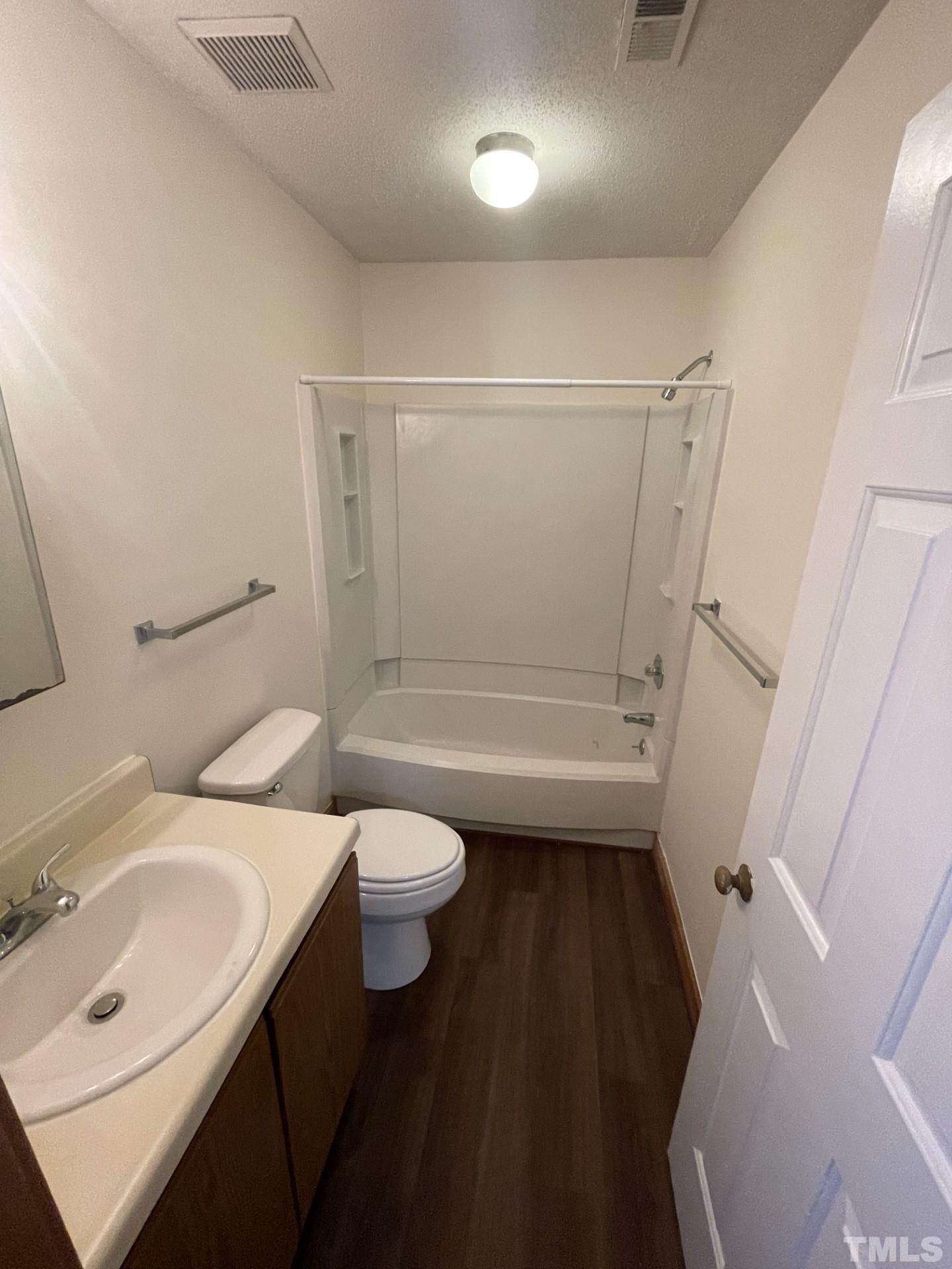 3511 Ivy Commons Drive, Unit 302 Raleigh, NC 27606 - Photo 7 of 9 a bathroom with a sink a toilet and shower