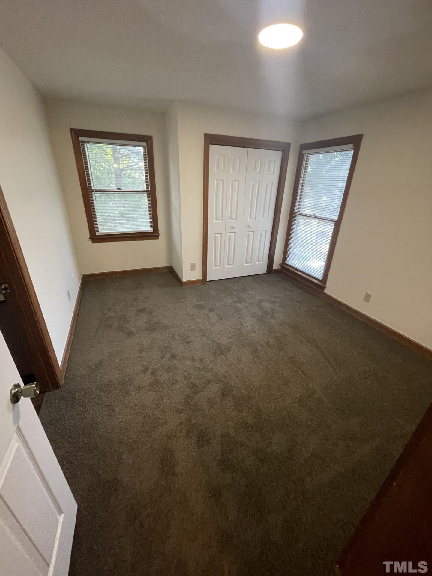 3511 Ivy Commons Drive, Unit 302 Raleigh, NC 27606 - Photo 8 of 9 an empty room with windows