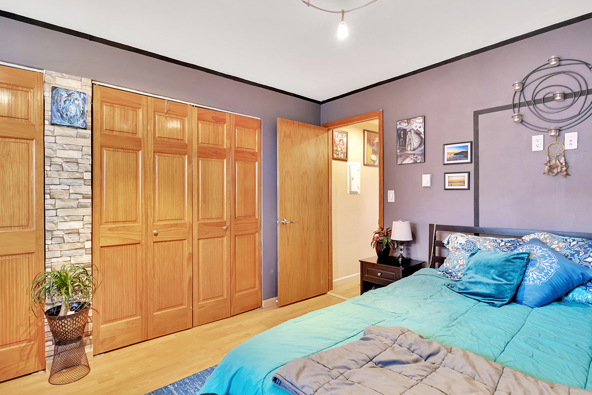 953 North Rohlwing Road, Unit 201A Addison, IL 60101 - Photo 12 of 20 a bedroom with a large bed and a potted plant