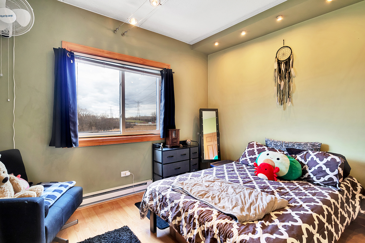 953 North Rohlwing Road, Unit 201A Addison, IL 60101 - Photo 15 of 20 a bedroom with a bed and a window