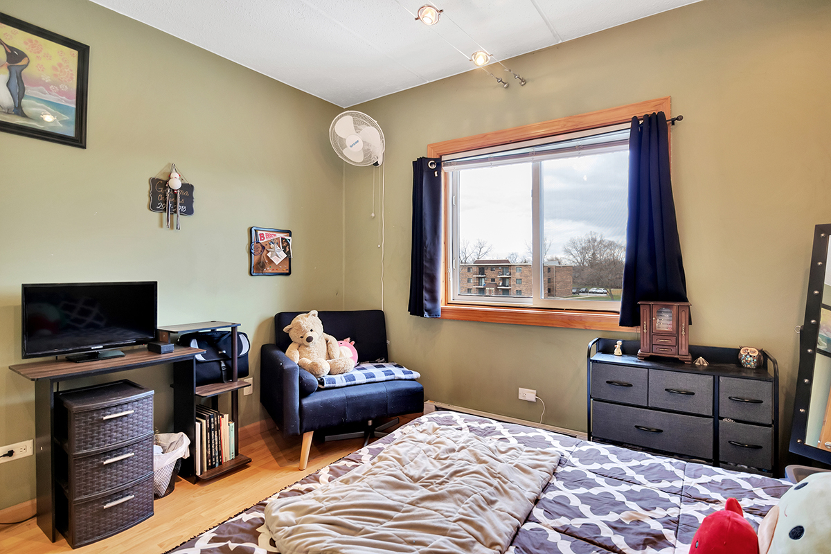 953 North Rohlwing Road, Unit 201A Addison, IL 60101 - Photo 16 of 20 a bedroom with a bed and furniture