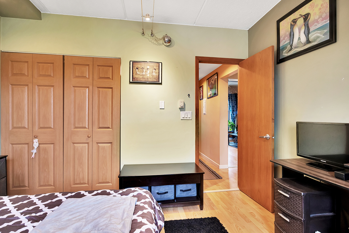 953 North Rohlwing Road, Unit 201A Addison, IL 60101 - Photo 17 of 20 a bedroom with a bed and a flat screen tv