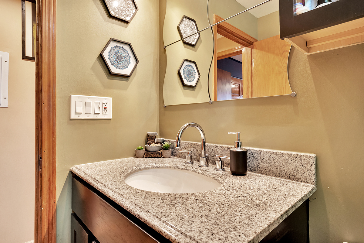 953 North Rohlwing Road, Unit 201A Addison, IL 60101 - Photo 18 of 20 a bathroom with a granite countertop sink and a mirror