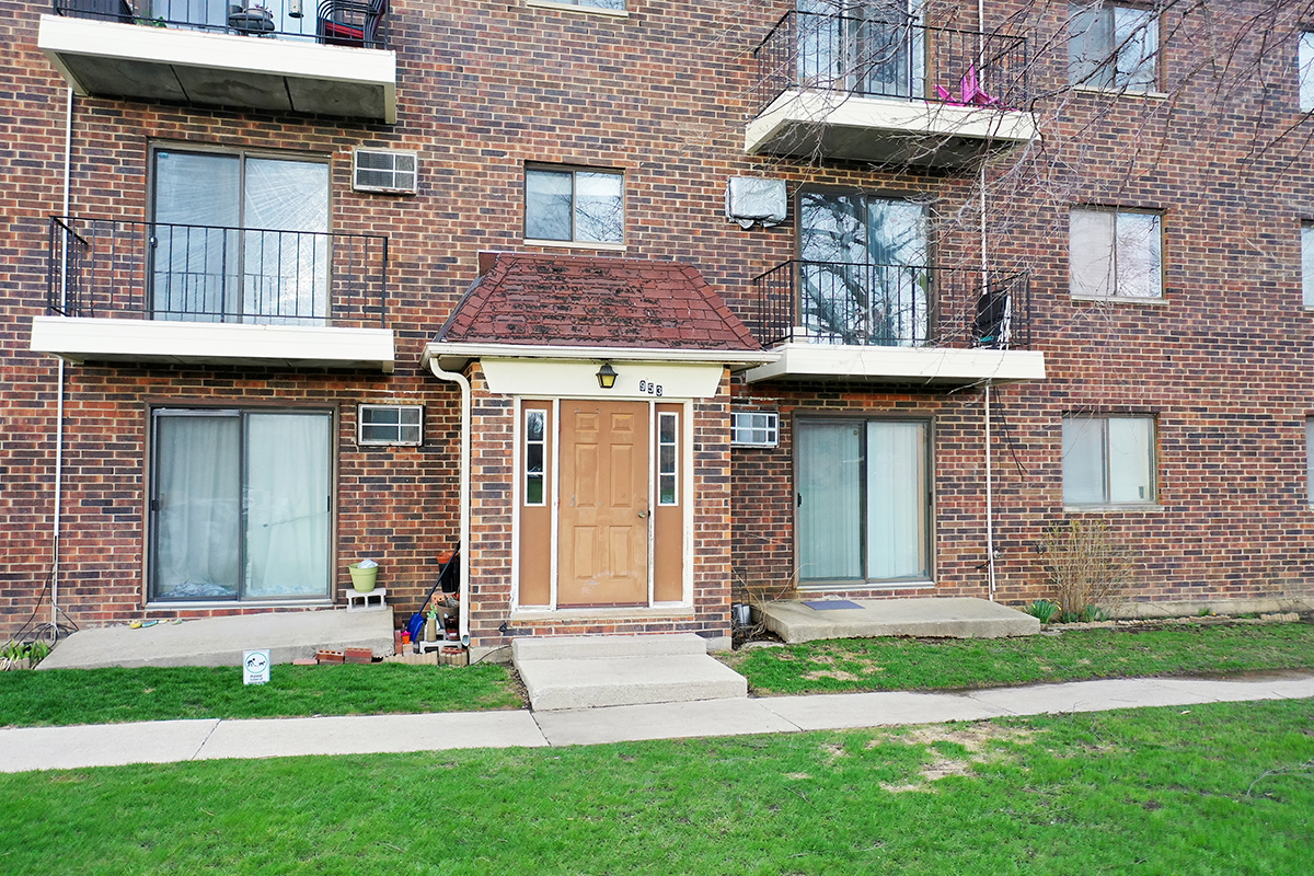 953 North Rohlwing Road, Unit 201A Addison, IL 60101 - Photo 19 of 20 a front view of a house with a garden and plants