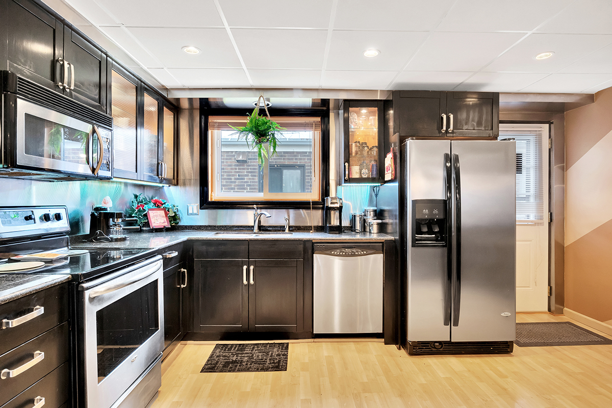 953 North Rohlwing Road, Unit 201A Addison, IL 60101 - Photo 7 of 20 a kitchen with stainless steel appliances granite countertop a refrigerator sink and stove