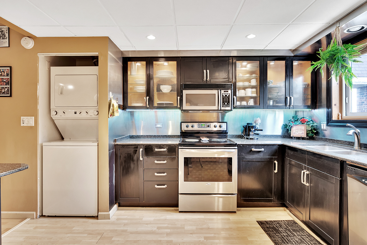 953 North Rohlwing Road, Unit 201A Addison, IL 60101 - Photo 8 of 20 a kitchen with stainless steel appliances granite countertop a stove a sink and a refrigerator
