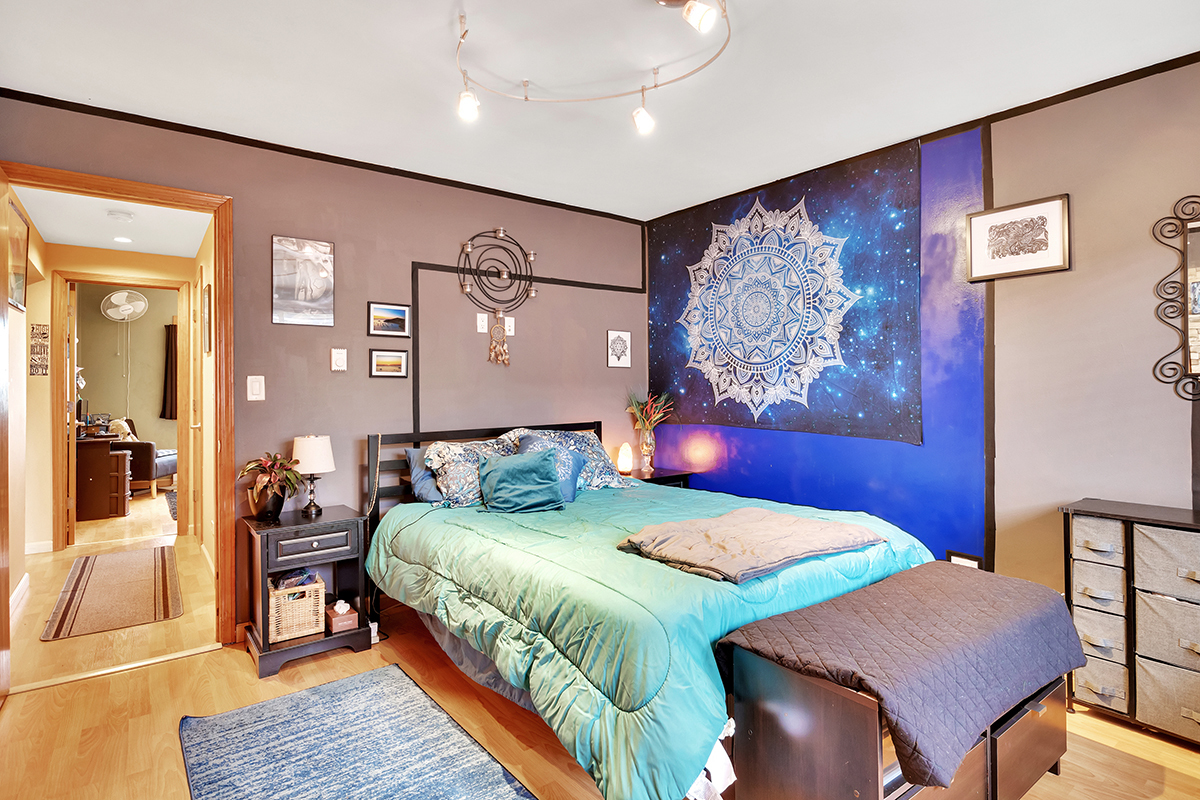 953 North Rohlwing Road, Unit 201A Addison, IL 60101 - Photo 10 of 20 a bedroom with a bed and wooden floor