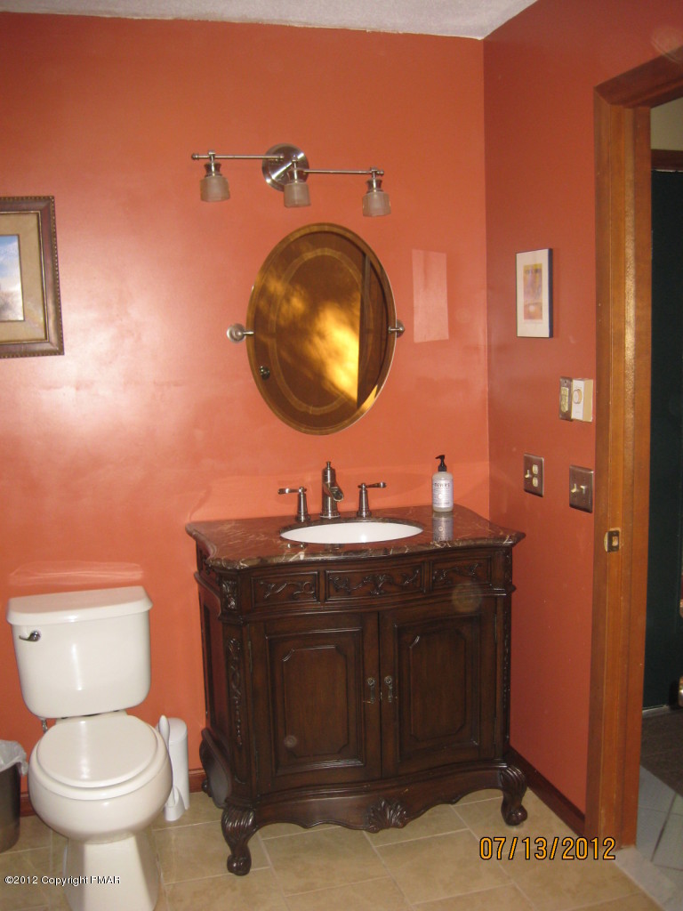 116 Grouse Road East Stroudsburg, PA 18301 - Photo 13 of 31 a bathroom with a toilet a sink and mirror