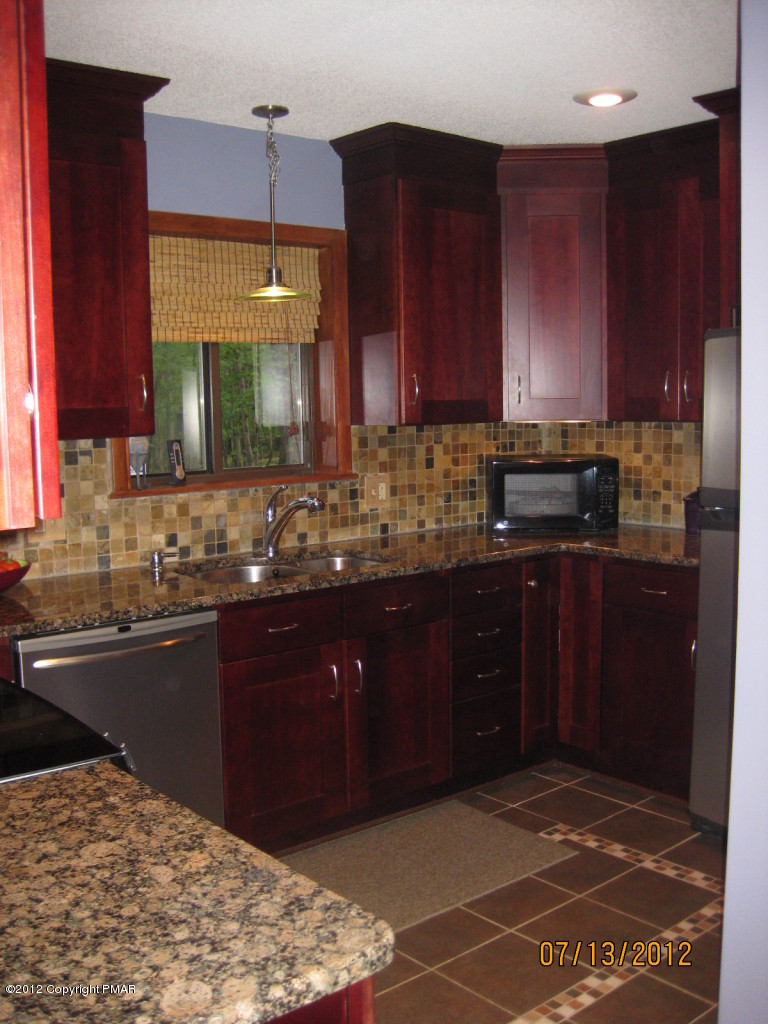 116 Grouse Road East Stroudsburg, PA 18301 - Photo 3 of 31 a kitchen with a sink cabinets and wooden floor