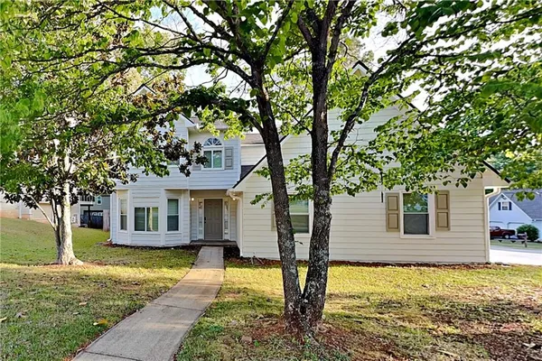 a front view of a house with a yard