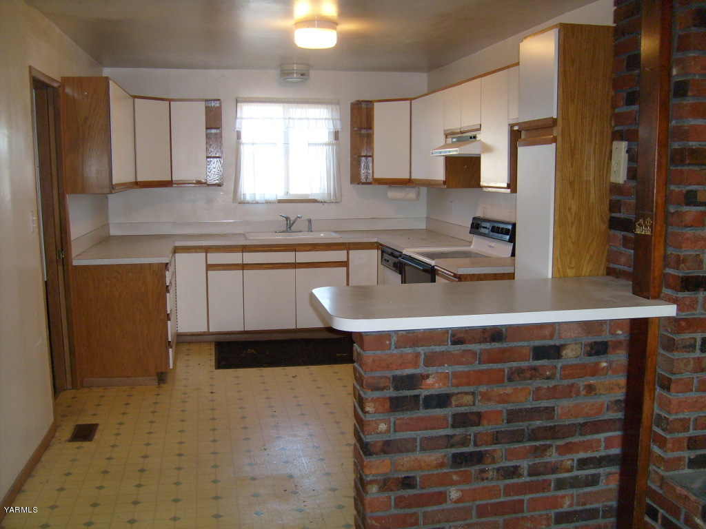 1203 Northbank Road Outlook, WA 98938 - Photo 5 of 6 a kitchen with stainless steel appliances a sink stove and cabinets