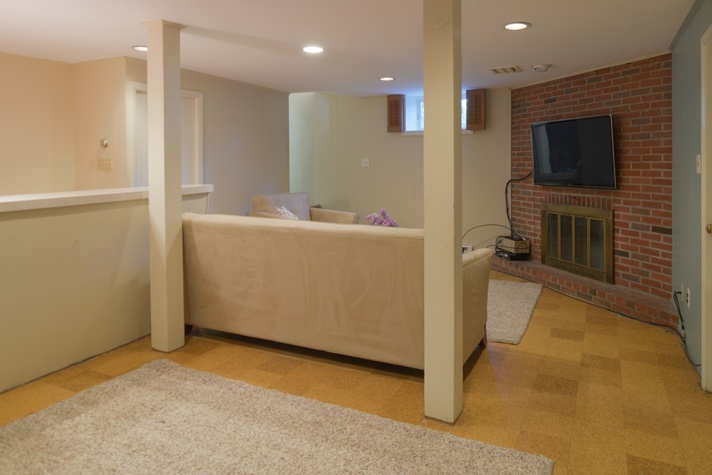42 Cornell Road Marblehead, MA 01945 - Photo 23 of 30 a living room with a flat screen tv and a fireplace