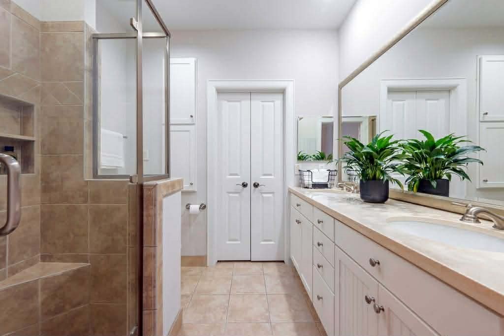 2210 Mid Lane, Unit 107 Houston, TX 77027 - Photo 11 of 15 a bathroom with double vanity and a mirror