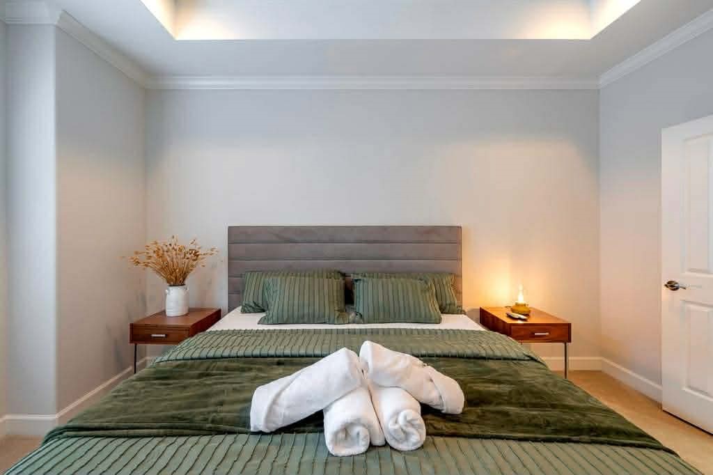 2210 Mid Lane, Unit 107 Houston, TX 77027 - Photo 12 of 15 a bedroom with furniture and a wooden floor