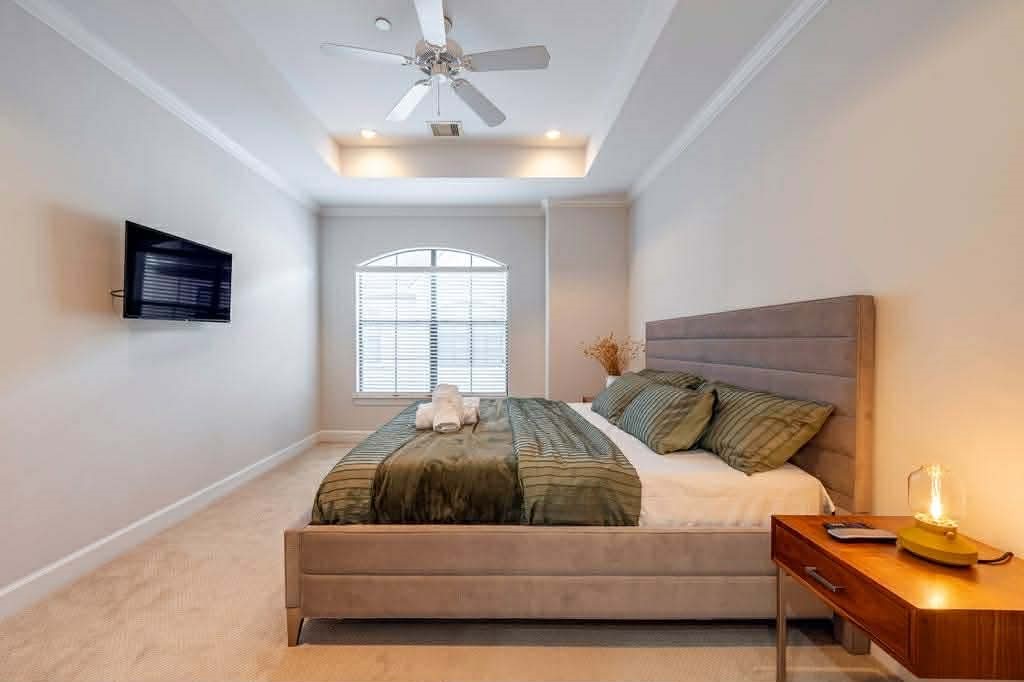 2210 Mid Lane, Unit 107 Houston, TX 77027 - Photo 13 of 15 a bedroom with a bed and a tv