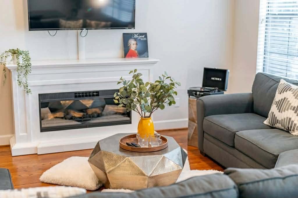 2210 Mid Lane, Unit 107 Houston, TX 77027 - Photo 2 of 15 a living room with furniture and a fireplace