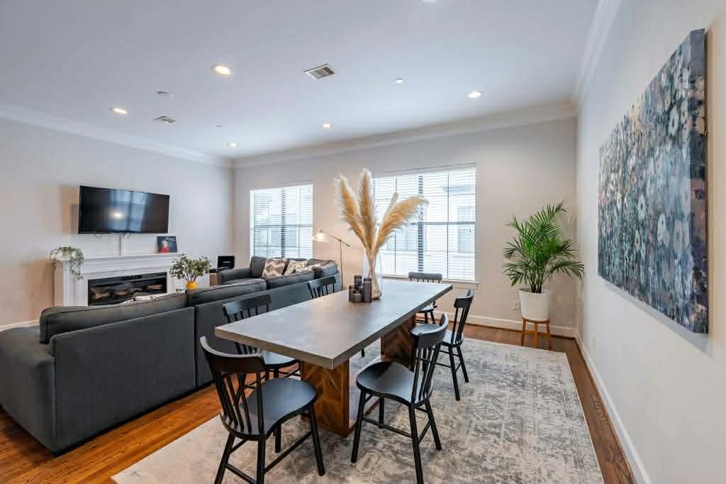 2210 Mid Lane, Unit 107 Houston, TX 77027 - Photo 4 of 15 a view of a dining room with furniture window and wooden floor