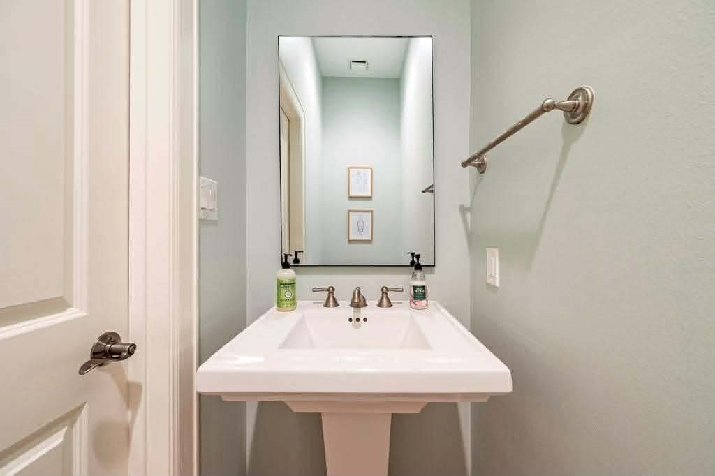 2210 Mid Lane, Unit 107 Houston, TX 77027 - Photo 7 of 15 a bathroom with a sink and a mirror