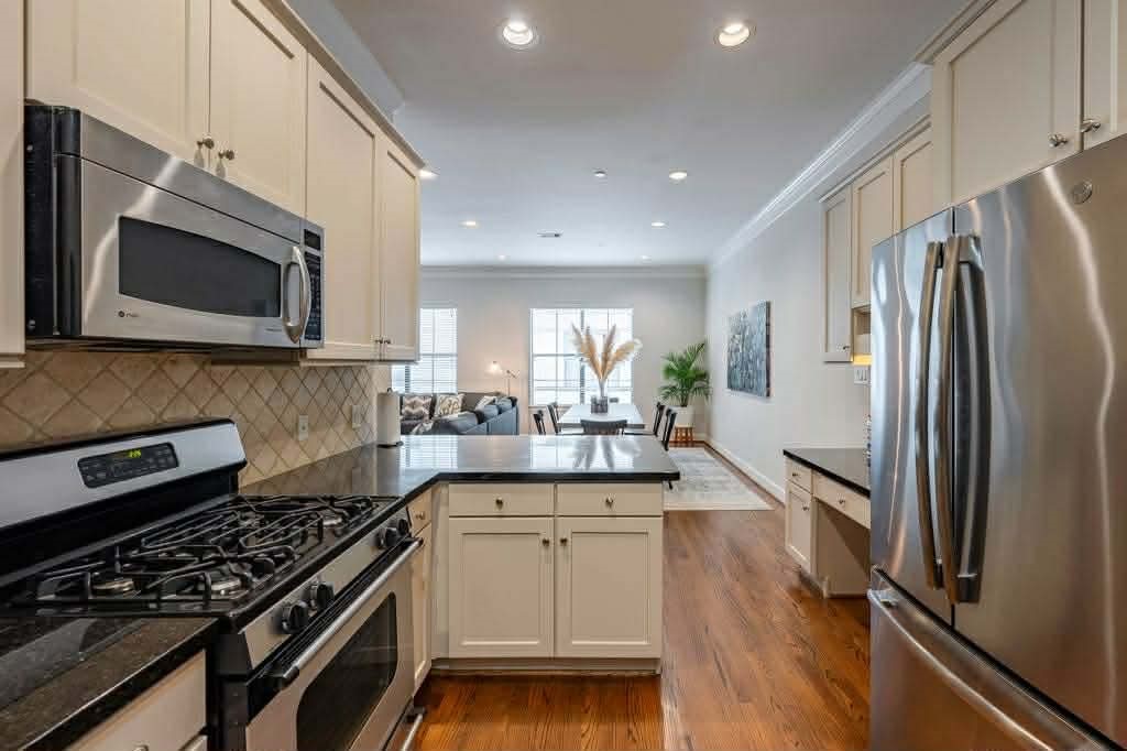 2210 Mid Lane, Unit 107 Houston, TX 77027 - Photo 8 of 15 a kitchen with stainless steel appliances a stove microwave and sink