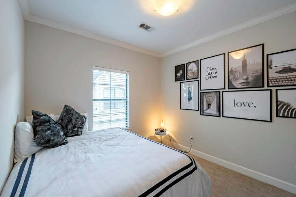 2210 Mid Lane, Unit 107 Houston, TX 77027 - Photo 9 of 15 a bedroom with a bed and two windows